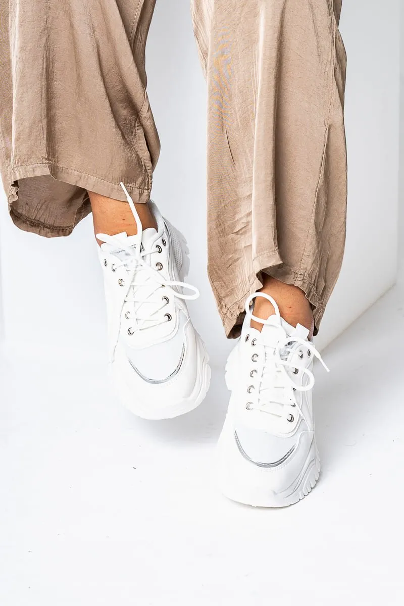 White bi-material platform sneakers with gold details.