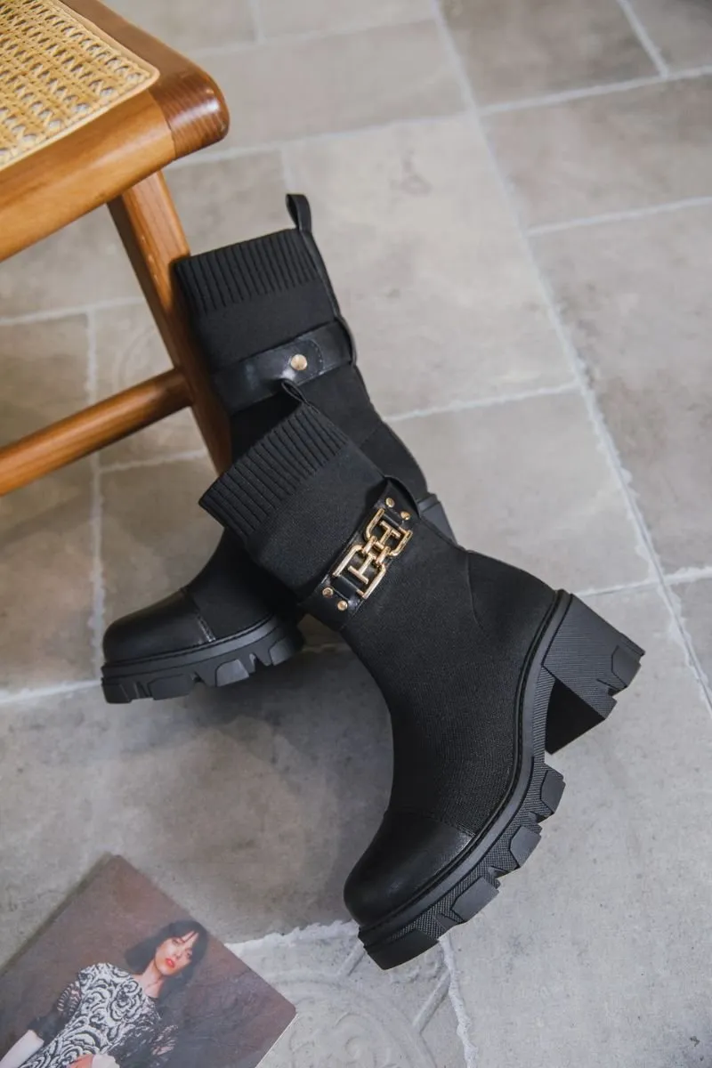 Black sock-style belt boots.