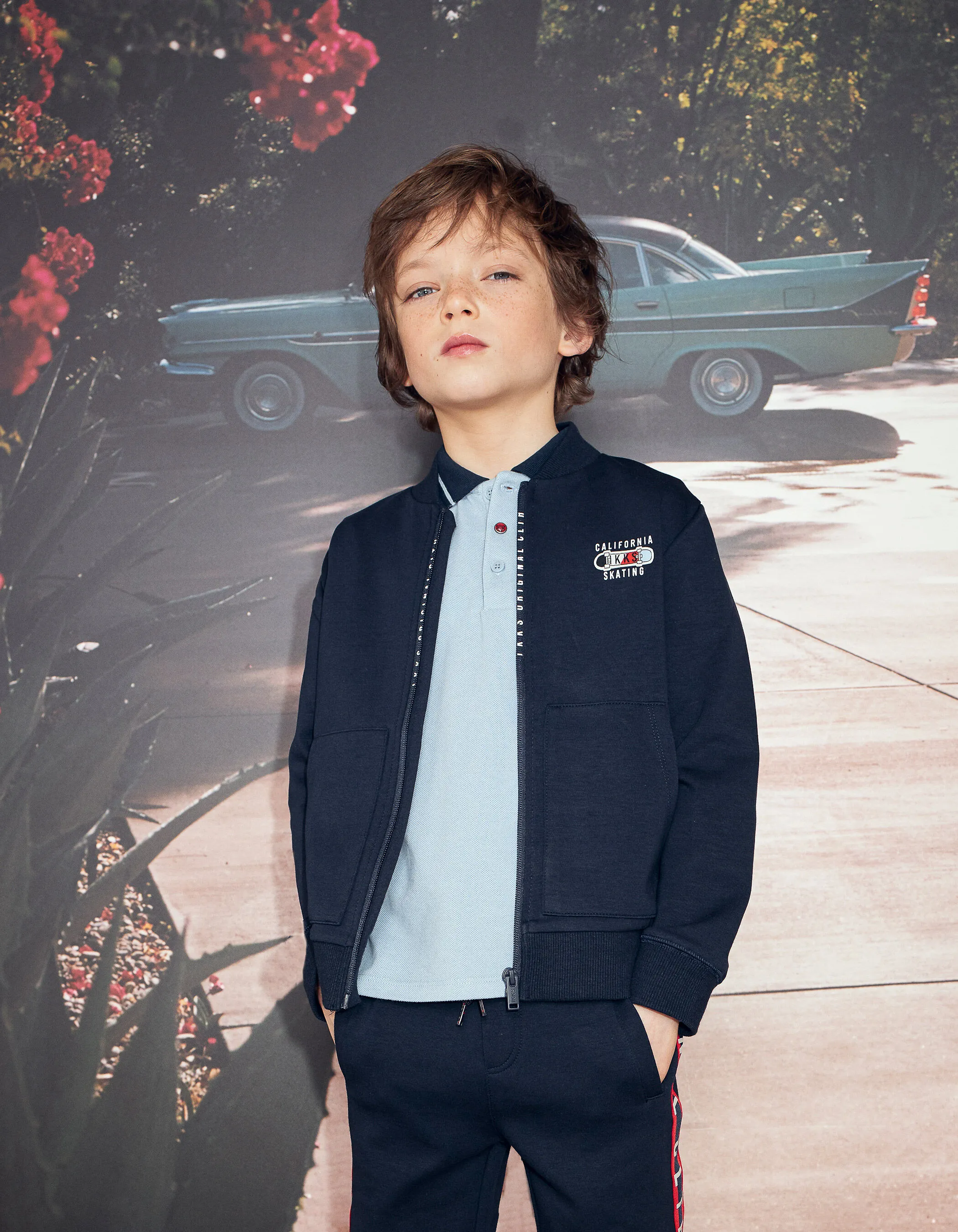 Cardigan bomber jacket in navy blue for boys by IKKS with fun design on the back.