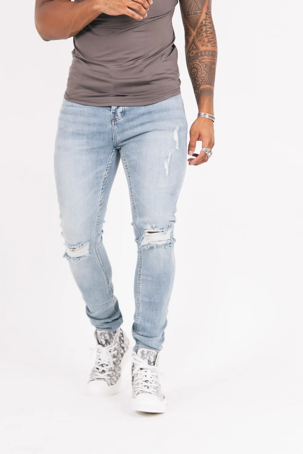 Distressed blue denim jeans