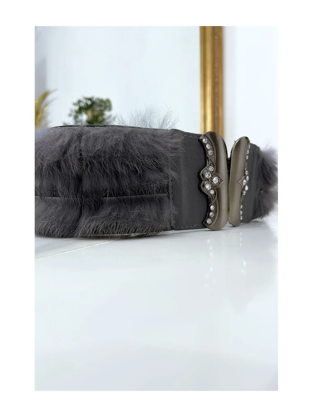 Gray Elastic Belt with Accessory and Feather.