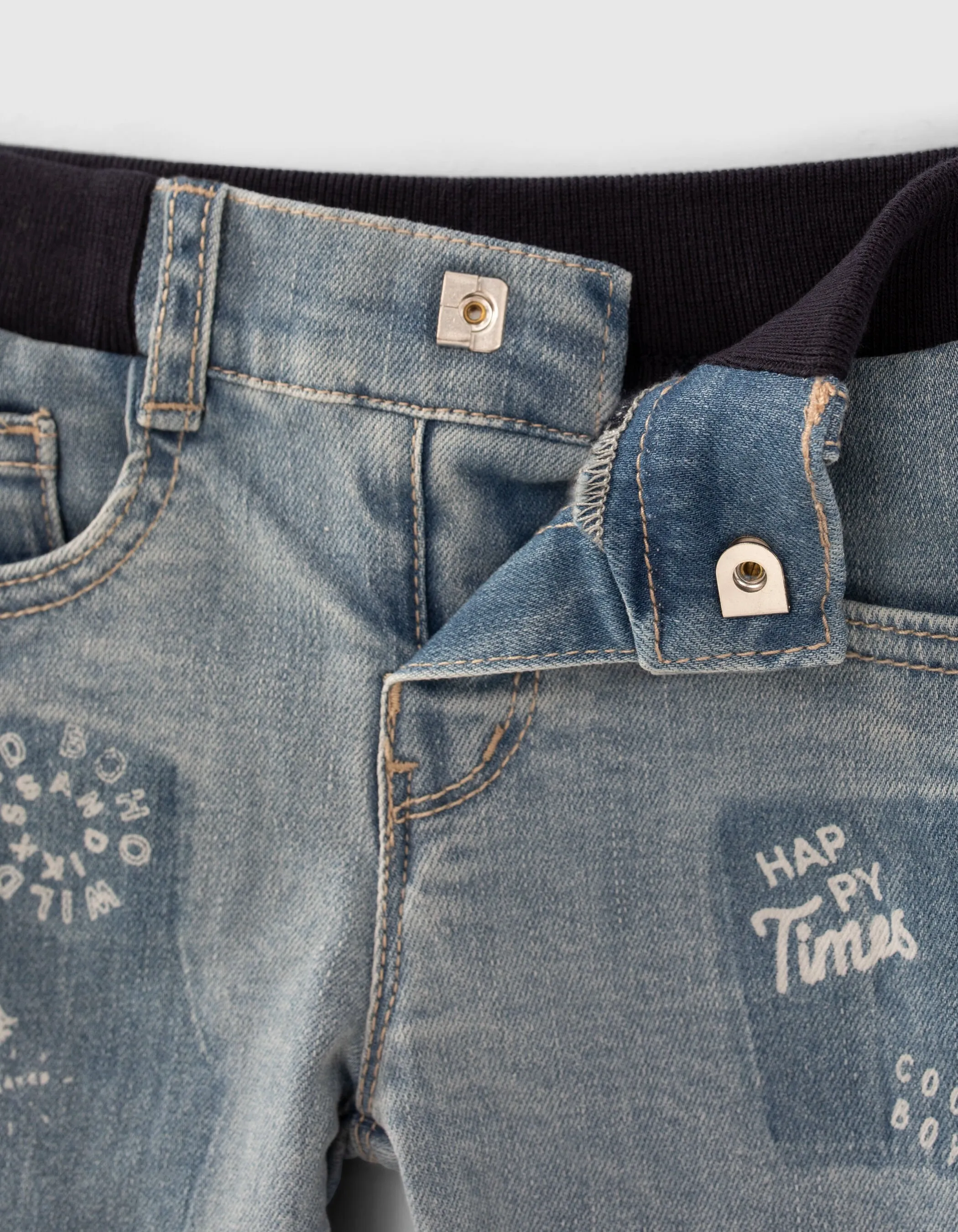 Blue jeans with print and baby boy badge.