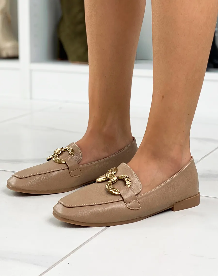 Light brown flat moccasins with double gold buckles.