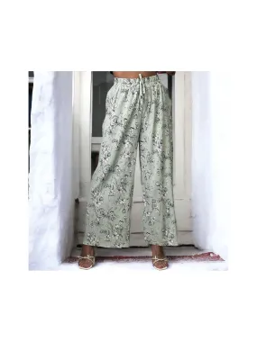 Wide leg green pleated palazzo pants with floral print.