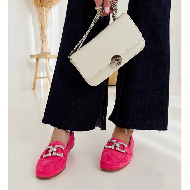 Pink moccasins embellished with a Kuens chain.