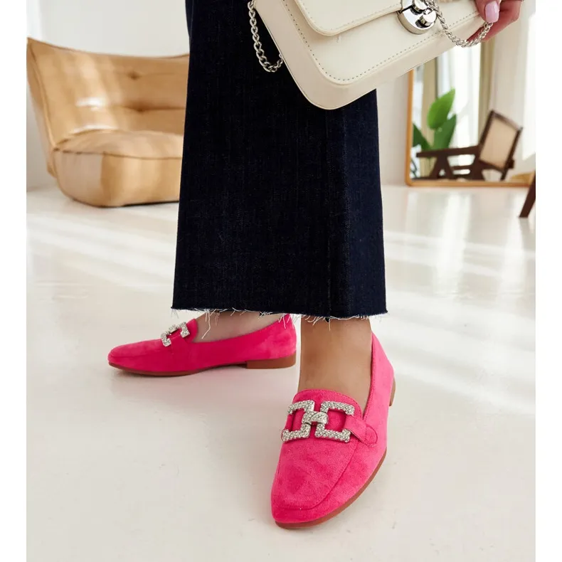 Pink moccasins embellished with a Kuens chain.