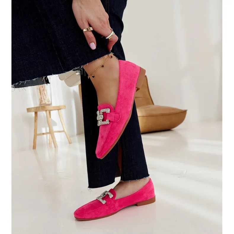 Pink moccasins embellished with a Kuens chain.