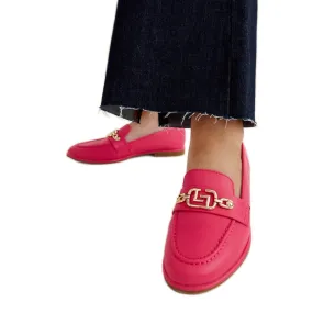 Pink moccasins embellished with a Kuens chain.