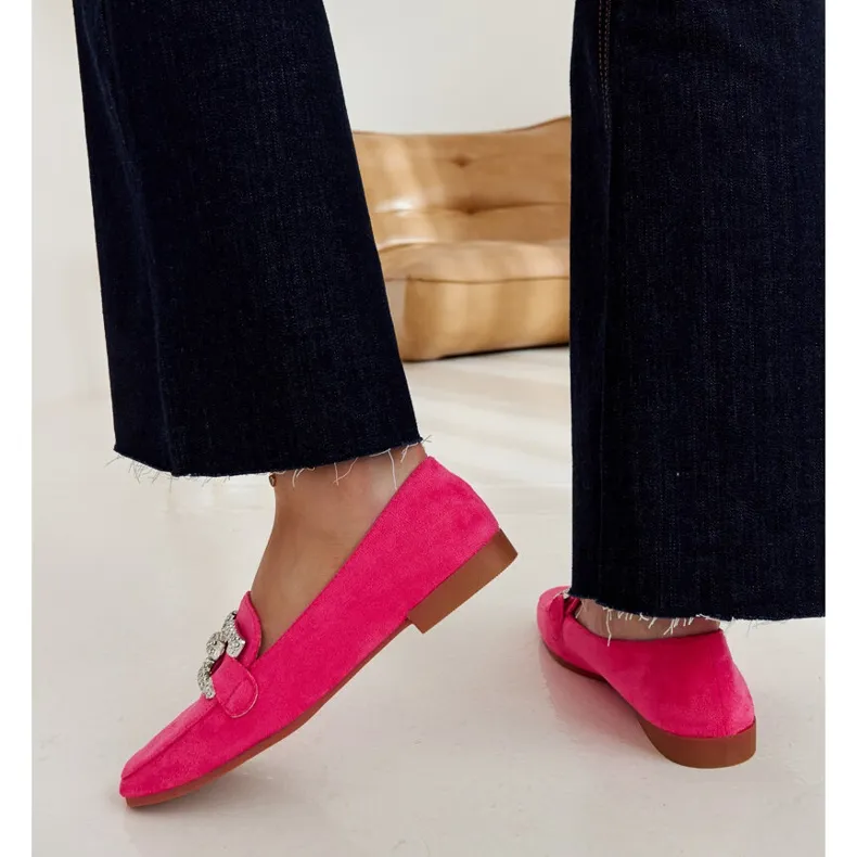 Pink moccasins embellished with a Kuens chain.