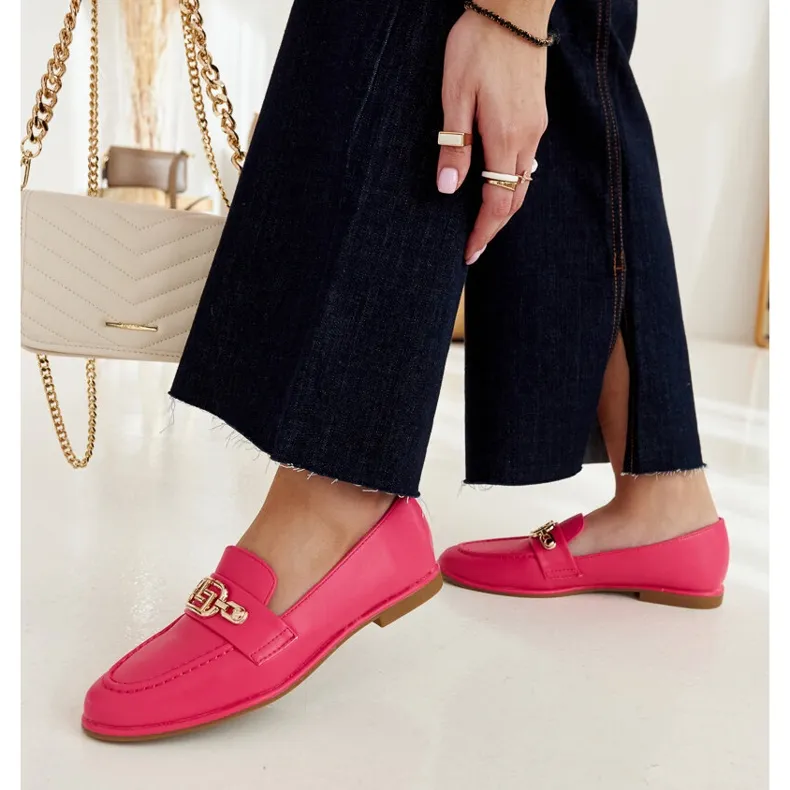 Pink moccasins embellished with a Kuens chain.