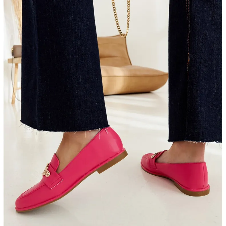 Pink moccasins embellished with a Kuens chain.