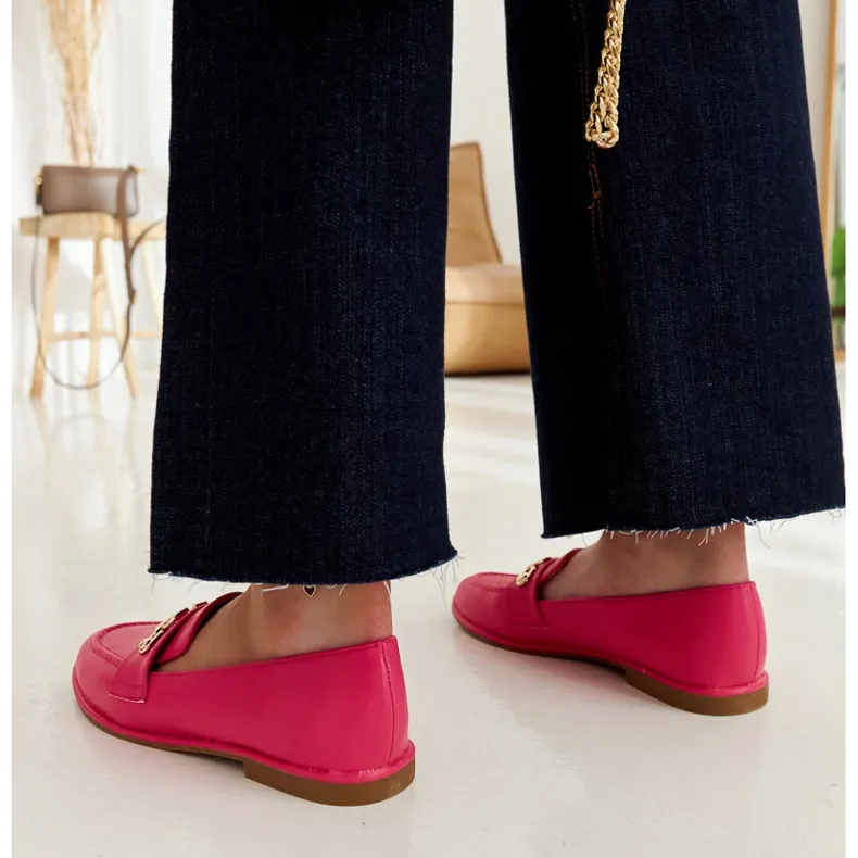 Pink moccasins embellished with a Kuens chain.