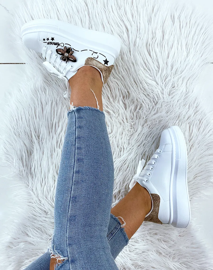 White platform sneakers with embroidered details.