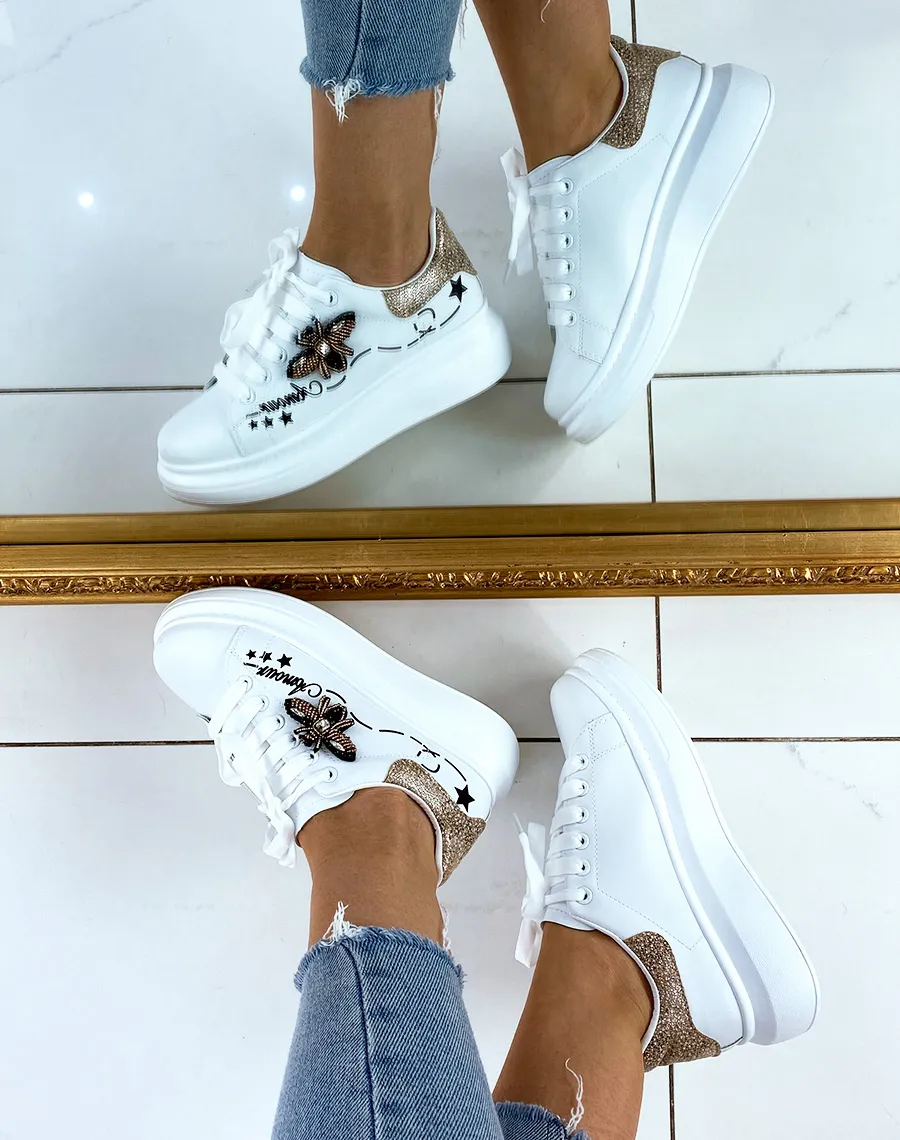 White platform sneakers with embroidered details.